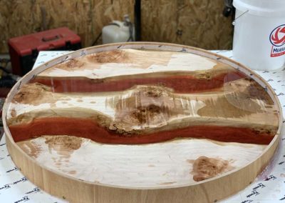 Red Epoxy Setting On Curly Maple Table